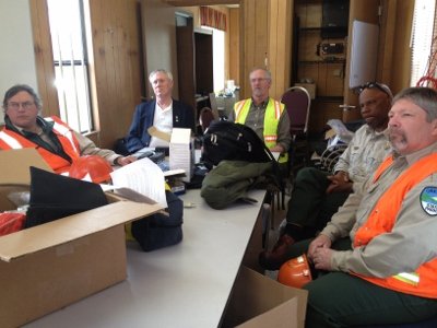 A safety training session in progress with participants in hi-vis