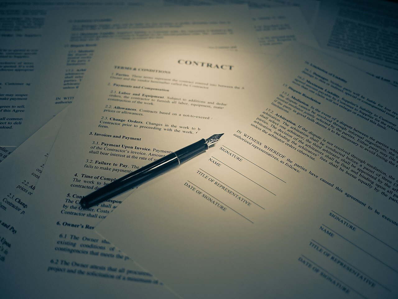 A contract document being reviewed and signed