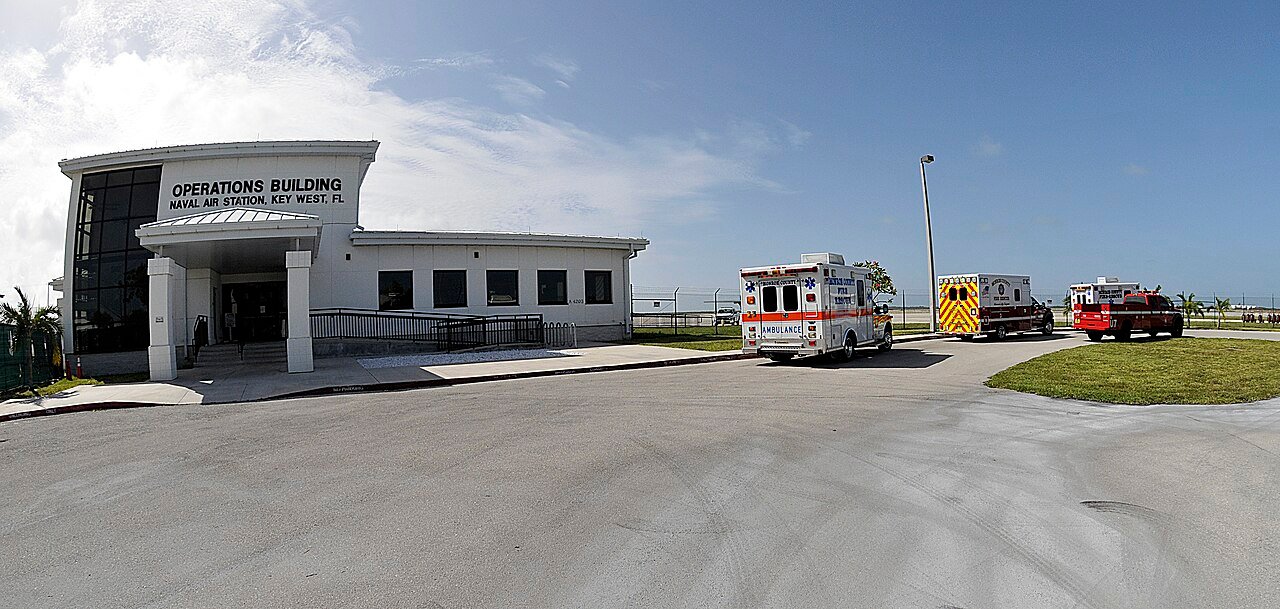 Emergency response vehicles staged outside a facility during a drill