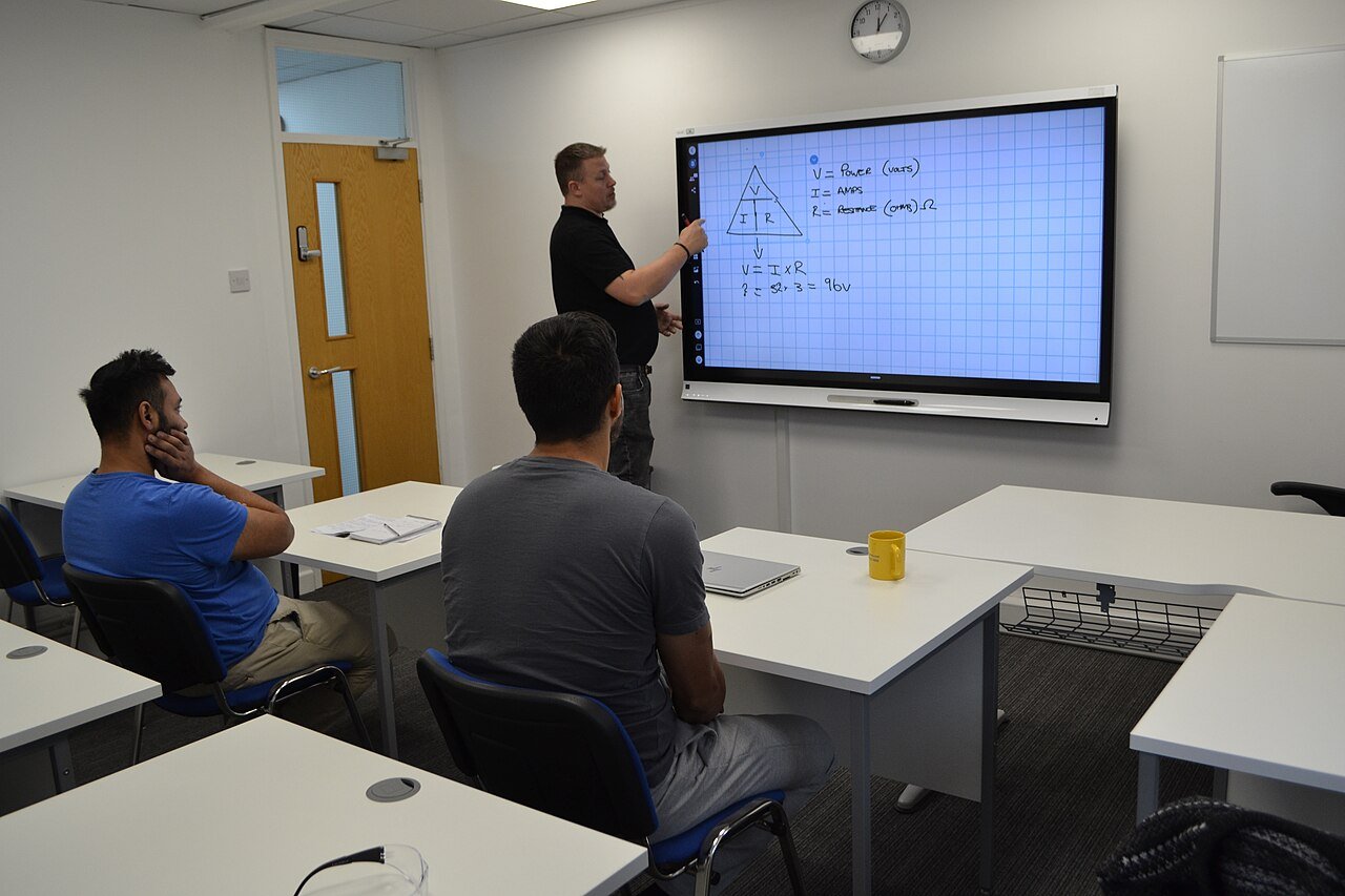 An instructor leading a technical training session in a classroom
