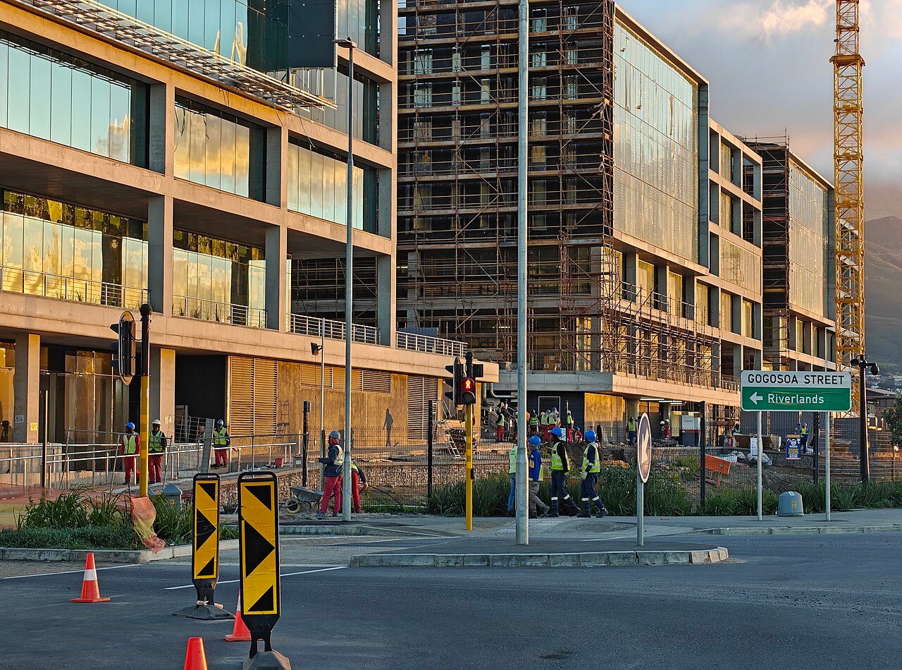 Construction crew in hi-vis and hard hats on a project site